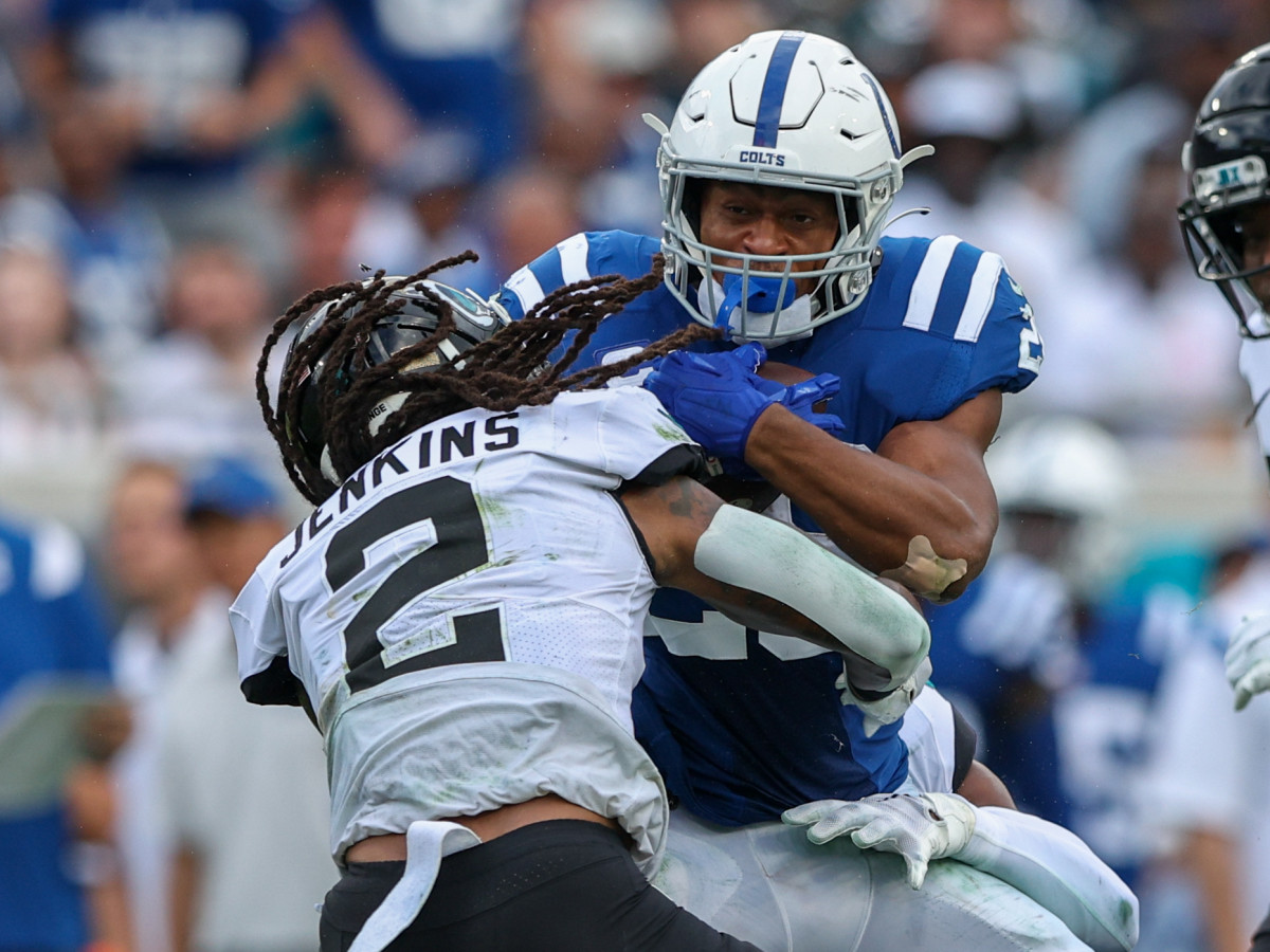 Jonathan Taylor is tackled by a Jaguars defender